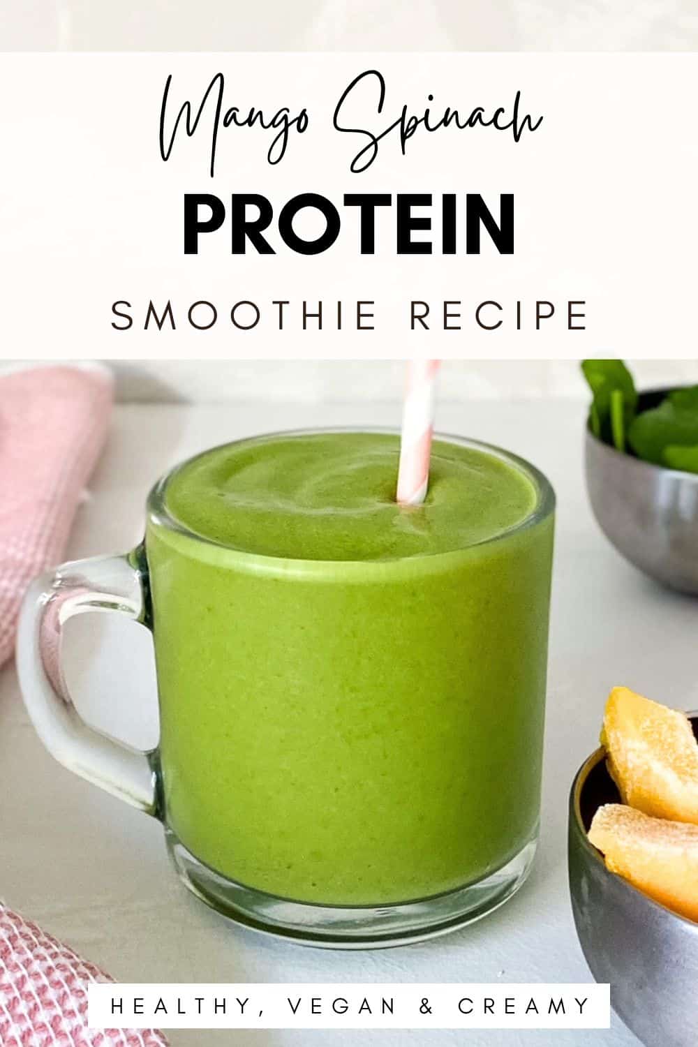 Glass mug filled with a creamy green mango spinach protein smoothie with a striped straw, styled with frozen mango and fresh spinach, overlaid text reads “Mango Spinach Protein Smoothie Recipe – Healthy, Vegan & Creamy.”