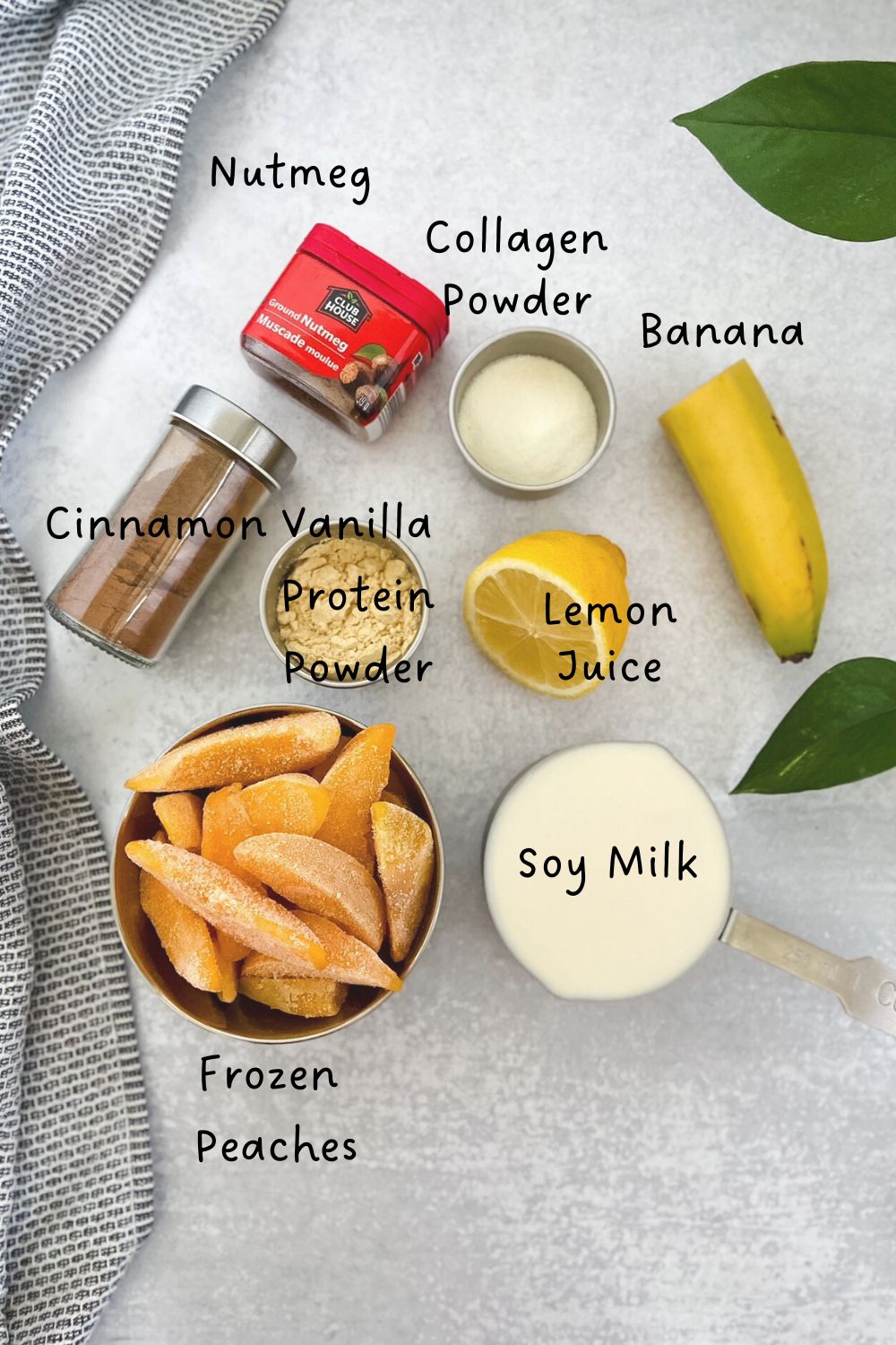 Flat lay of smoothie ingredients including frozen peaches, banana, soy milk, collagen, protein powder, cinnamon, nutmeg, and lemon.