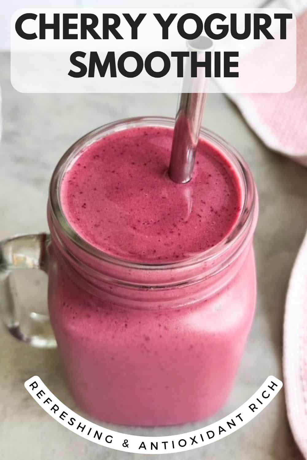 Cherry yogurt smoothie in a glass mason jar with a straw, with text overlay reading cherry yogurt smoothie and refreshing and antioxidant rich