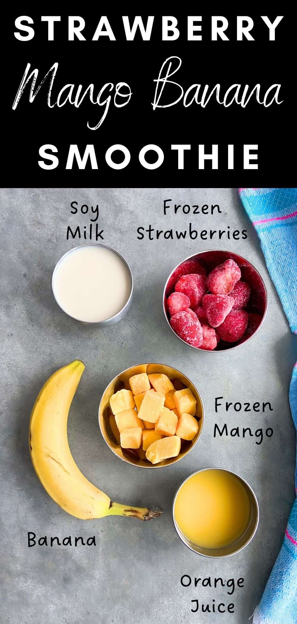Flat lay of smoothie ingredients including frozen strawberries, frozen mango, banana, soy milk, and orange juice on a gray surface with labeled text.