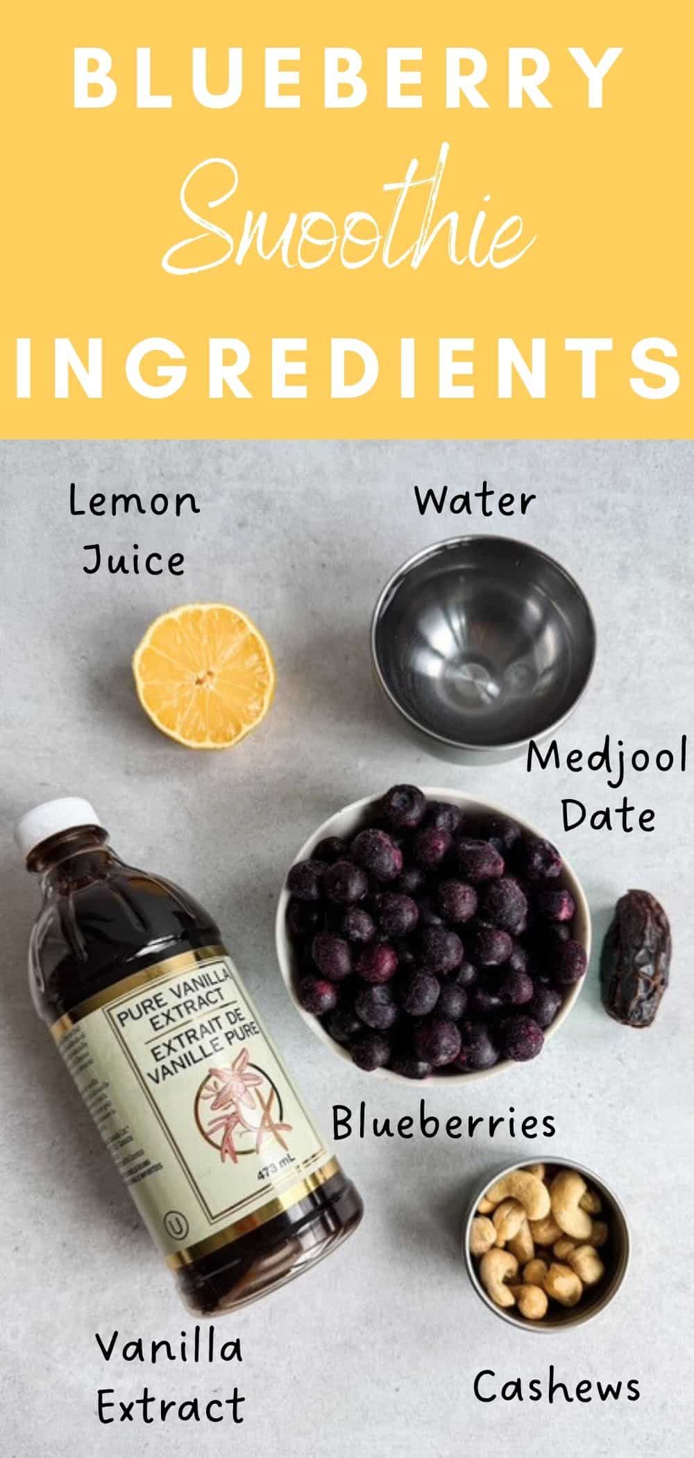 Ingredients for a blueberry smoothie including frozen blueberries, cashews, lemon juice, water, vanilla extract, and a Medjool date arranged on a countertop.