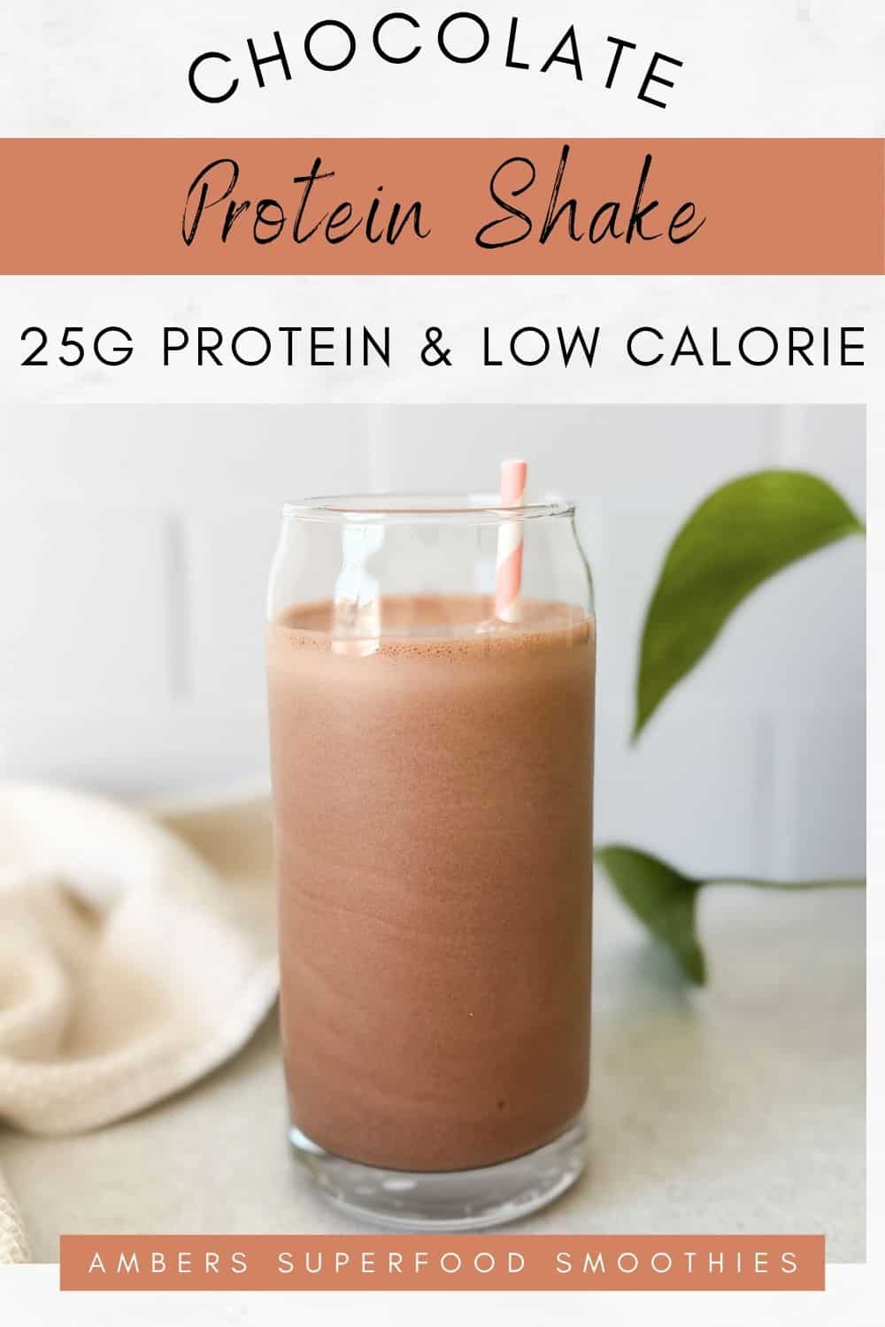 Pinterest pin featuring a chocolate protein shake in a tall clear glass with a pink striped straw, green plant leaves in the background, and text reading “Chocolate Protein Shake – 25g Protein & Low Calorie.”