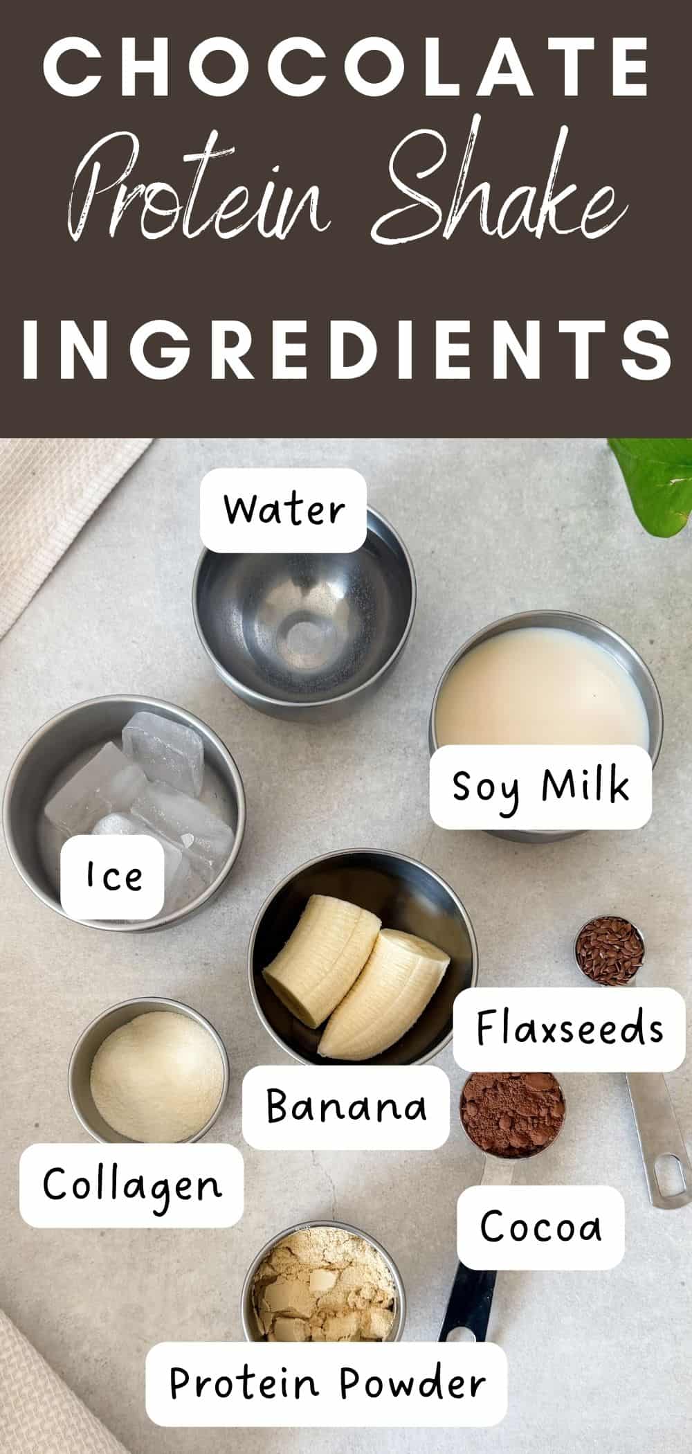 Overhead photo of chocolate protein shake ingredients in metal bowls, including banana, soy milk, water, ice, flaxseeds, cocoa powder, collagen peptides, and protein powder, with each ingredient labeled.